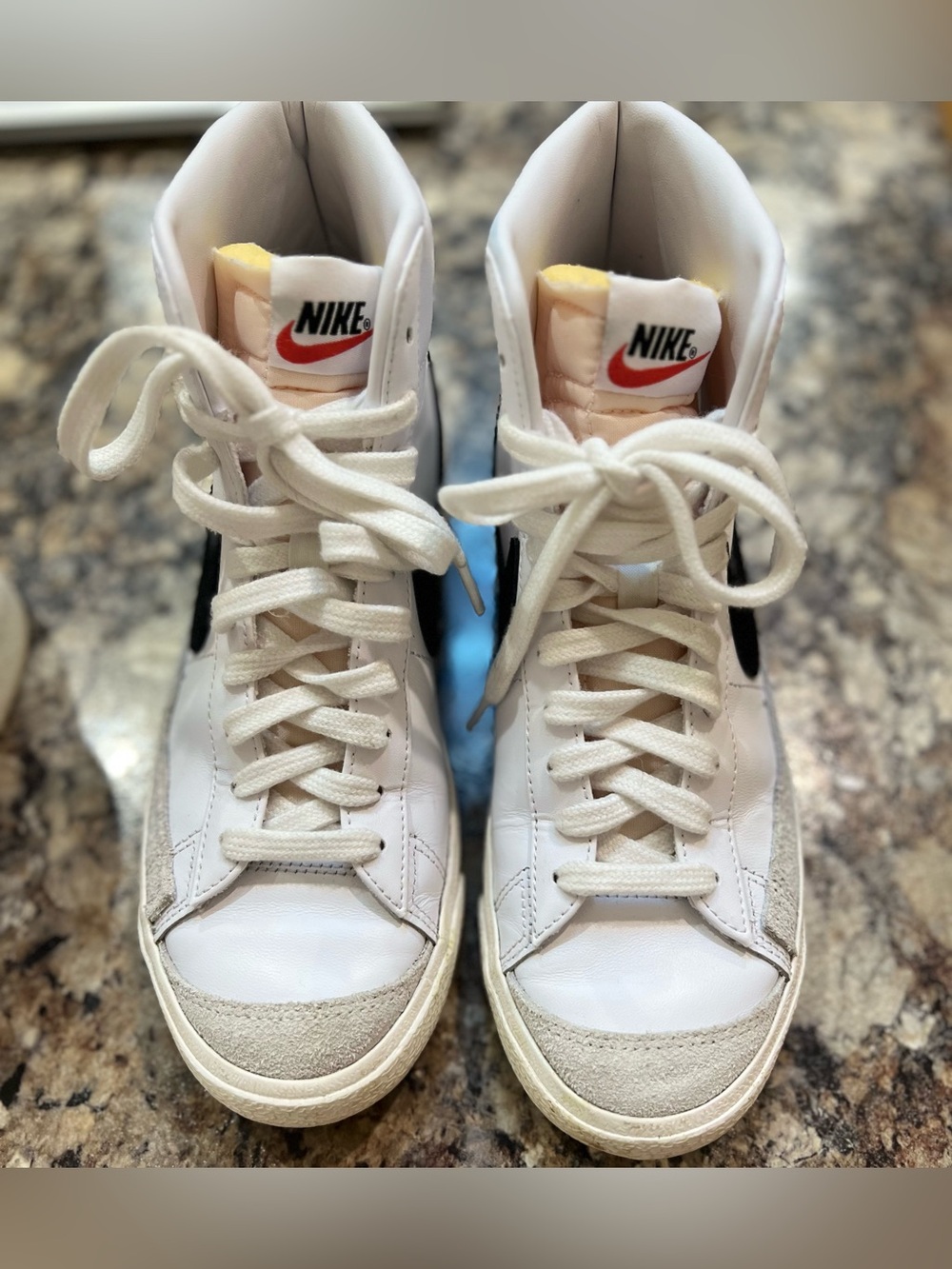 Nike Women's White High-Top Sneakers with Black Swoosh and Orange Tongue Logo